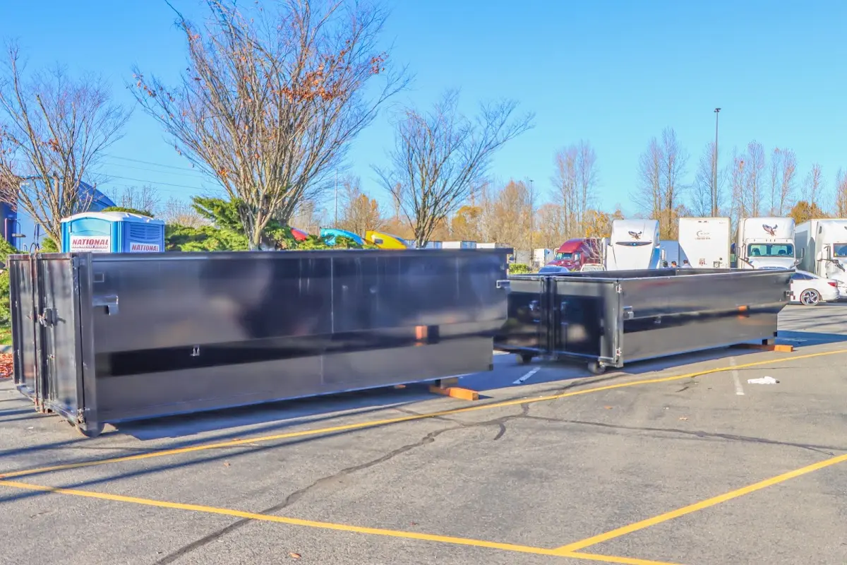 Professional dumpster rental service with roll-off container on residential driveway in Allamuchy